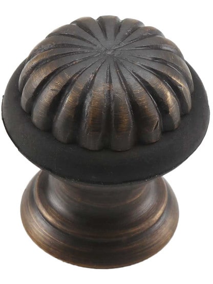 Fluted Floor-Mount Doorstop in Antique Brass.